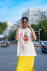 Second front view of an female model wearing an off-white oversized tee featuring Shinchan saying 