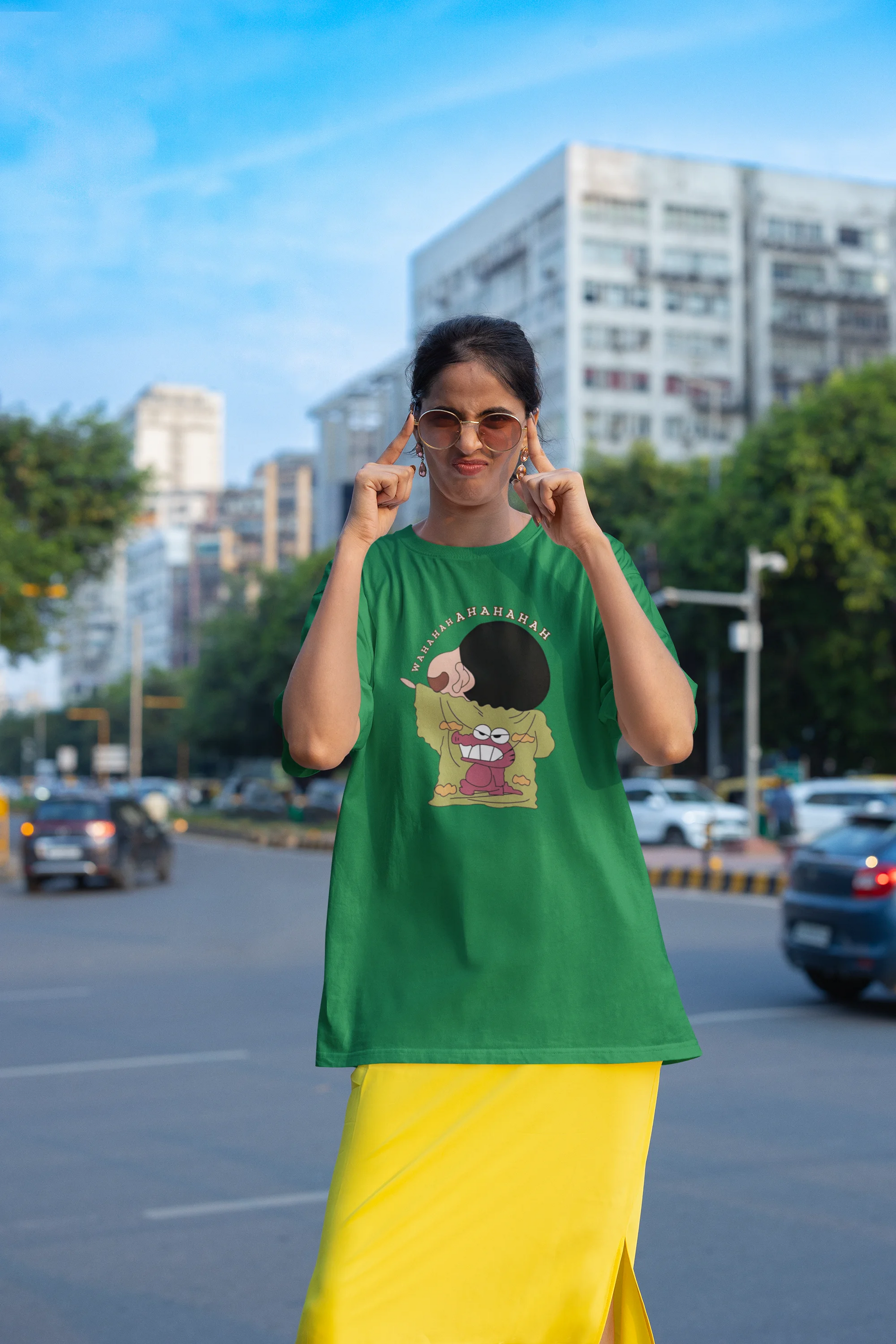 Second front view of female model wearing a forest green oversized t-shirt with a design of Shinchan laughing hysterically. Perfect for Shinchan fans who love the character's humor.