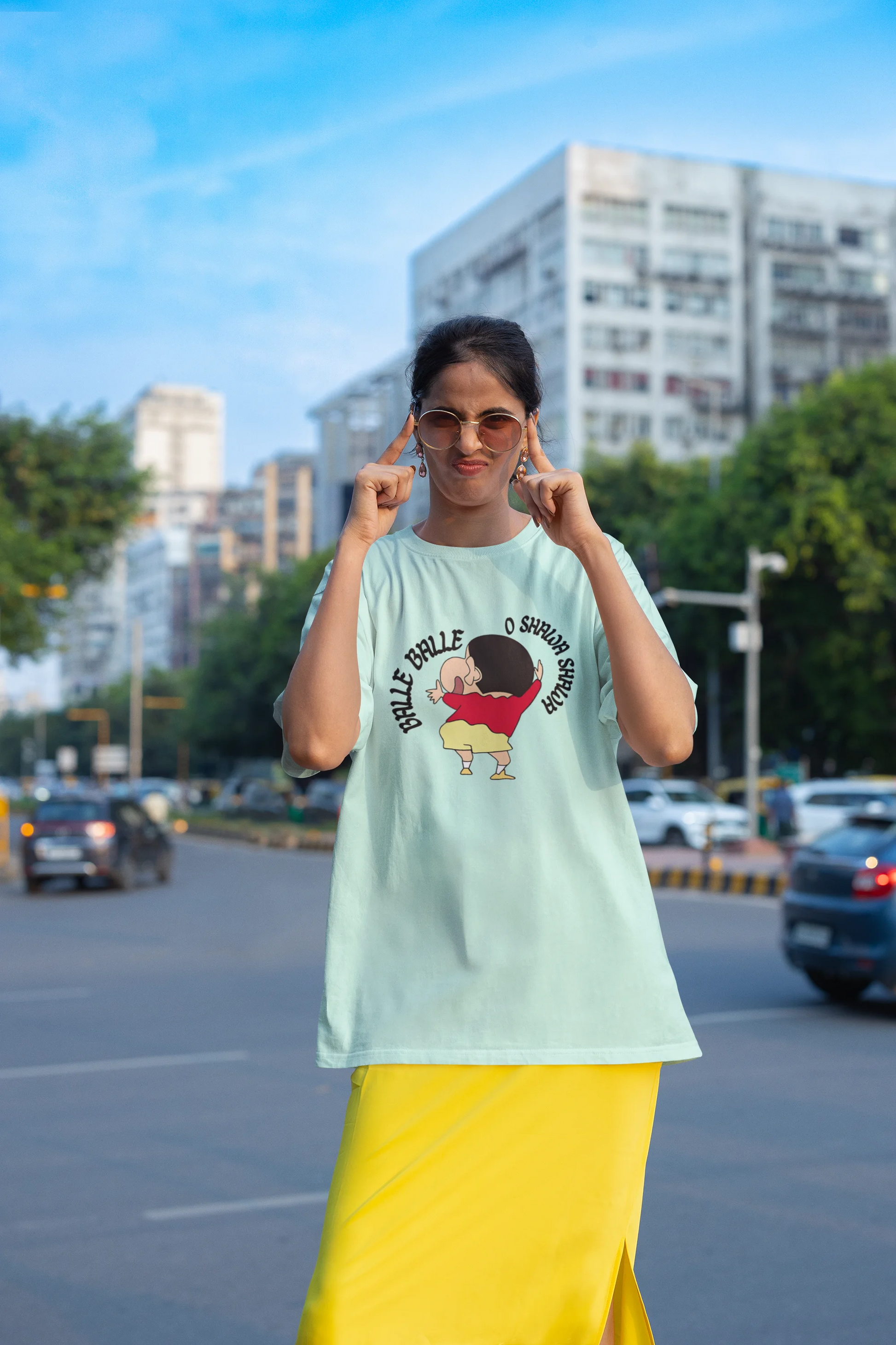 Third front view of female model wearing an oversized mint green tee with Shinchan dancing and the text "Balle Balle". A perfect blend of anime and Bollywood for Shinchan fans.