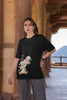 Second image of female model wearing black oversized tee with a Disney's Chip and Dale design, featuring the adorable duo in a playful scene.