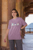 Third image of female model wearing Disney-themed dirty purple oversized tee with a cute cartoon design