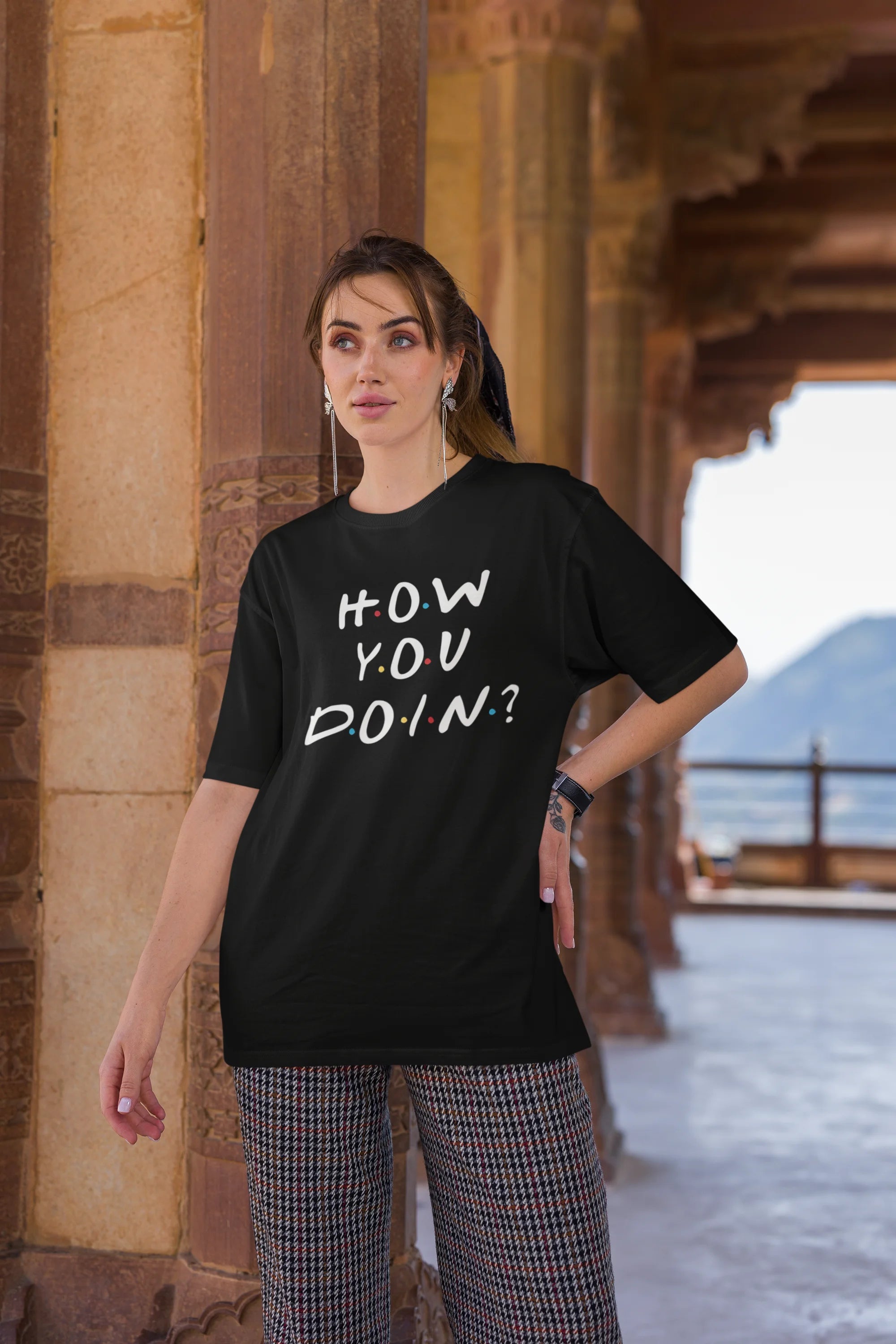 Third image of female model wearing black oversized t-shirt with F.R.I.E.N.D.S series inspired designs, embodying Joey's famous catchphrase 'How You Doin'?