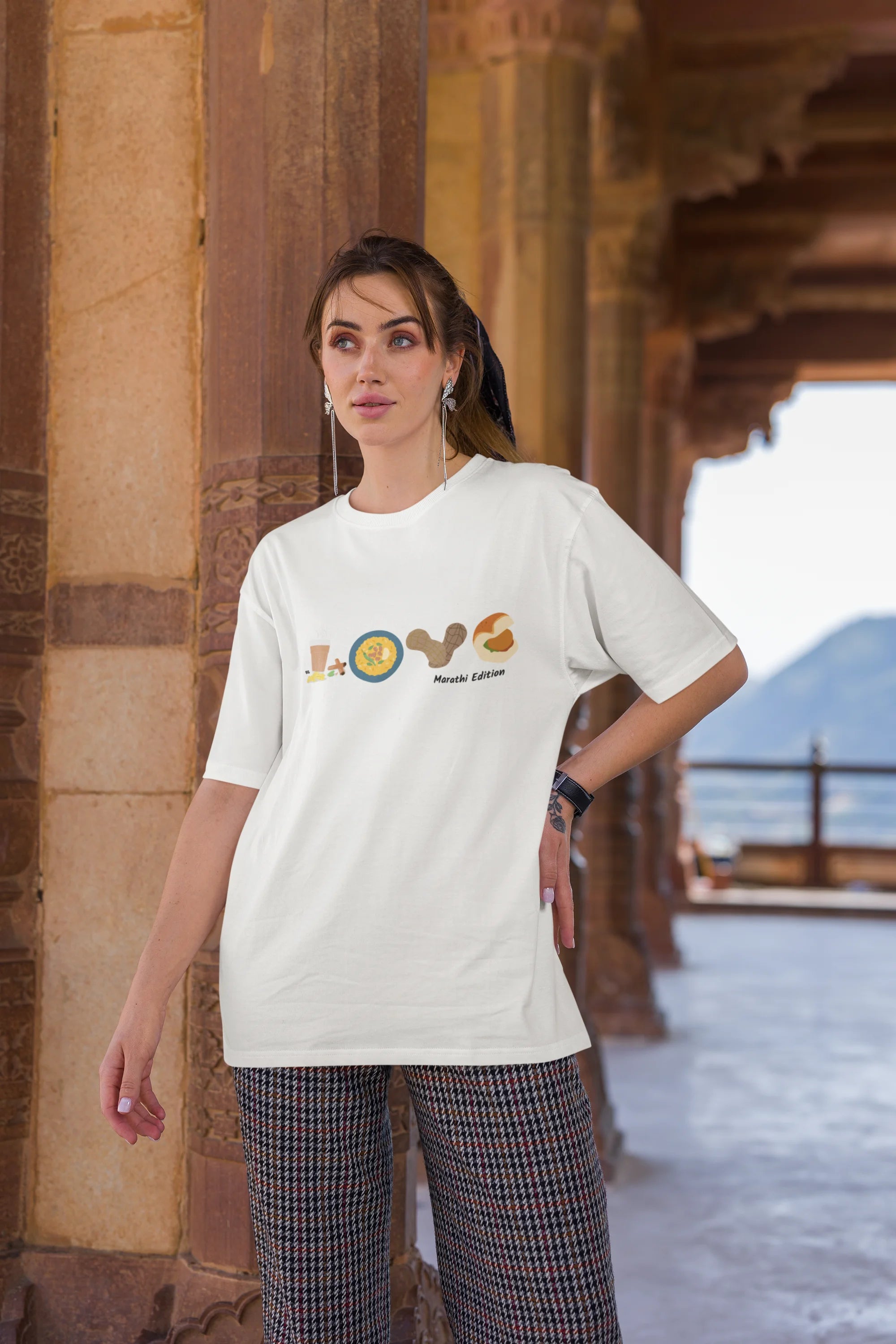 Third front view of a female model wearing an off-white oversized t-shirt with a colorful design that celebrates Marathi culture. Ideal for anyone who loves Maharashtra and its vibrant heritage.