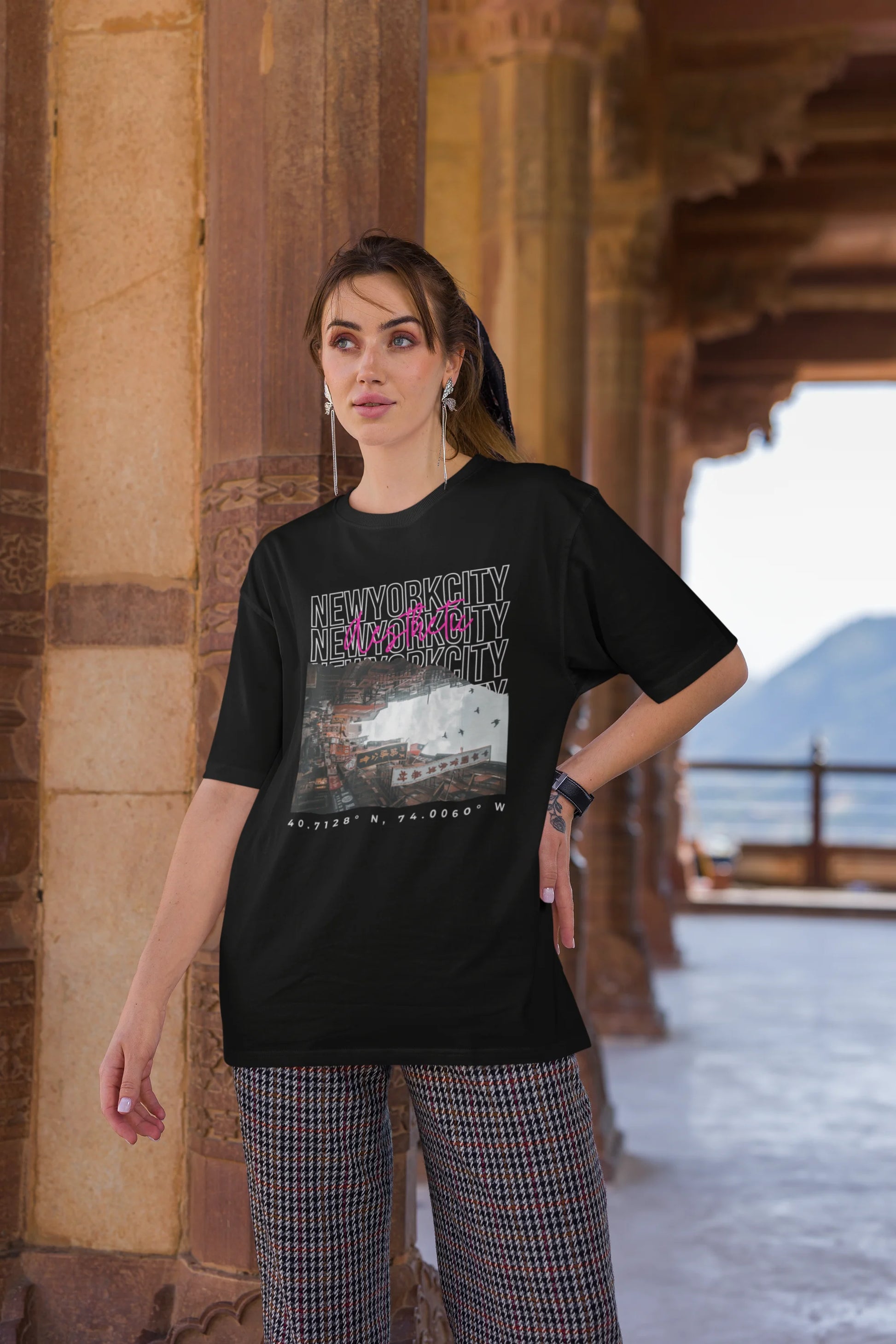 Second front view of a female model wearing an black oversized t-shirt with a New York City skyline design, offering a relaxed urban aesthetic.