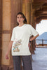 Second image of female model wearing off-white oversized tee with a Disney's Chip and Dale design, featuring the adorable duo in a playful scene.