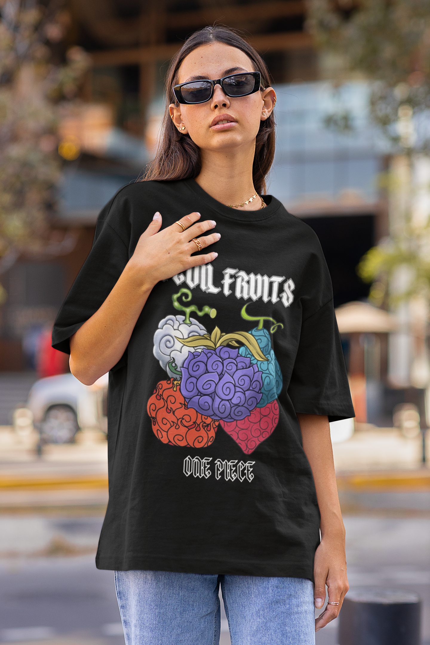 3rd front view of a female model wearing a black oversized t-shirt featuring a design of a Devil Fruit from the One Piece anime.