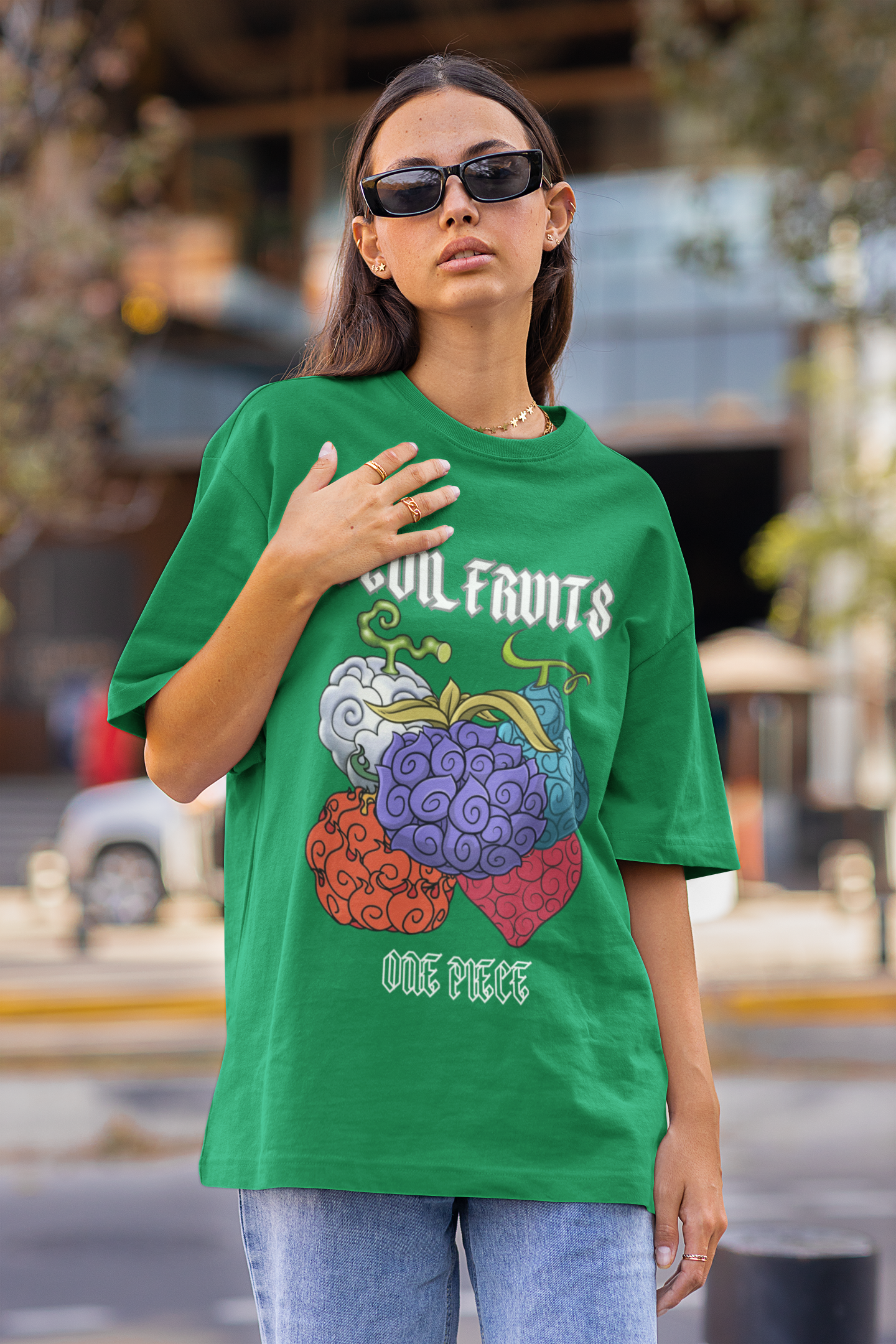 2nd front view of a female model wearing a forest green oversized t-shirt featuring a design of a Devil Fruit from the One Piece anime.