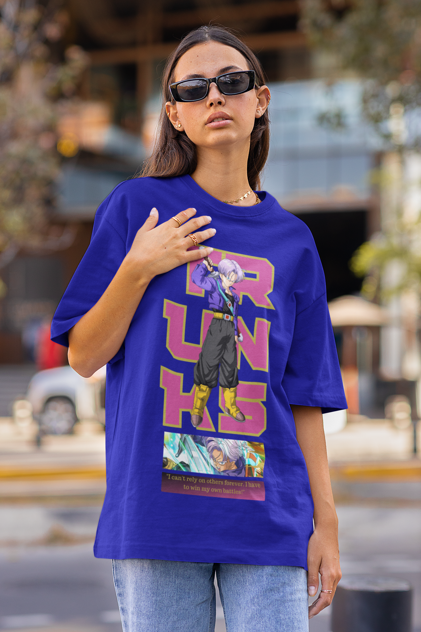 First front view of a female model wearing a royal blue oversized t-shirt featuring Trunks from Dragon Ball Z with the text "Trunks."