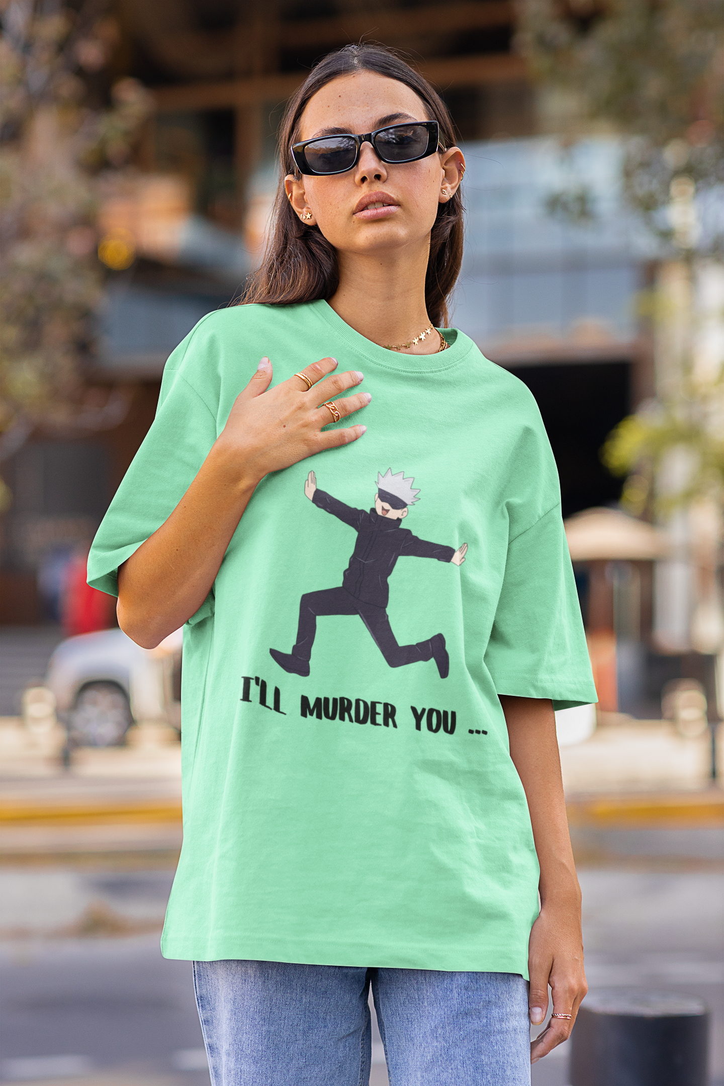 First front view of a female model wearing a mint green oversized t-shirt featuring Gojo Satoru in a silly pose with the text "I Will Murder You."