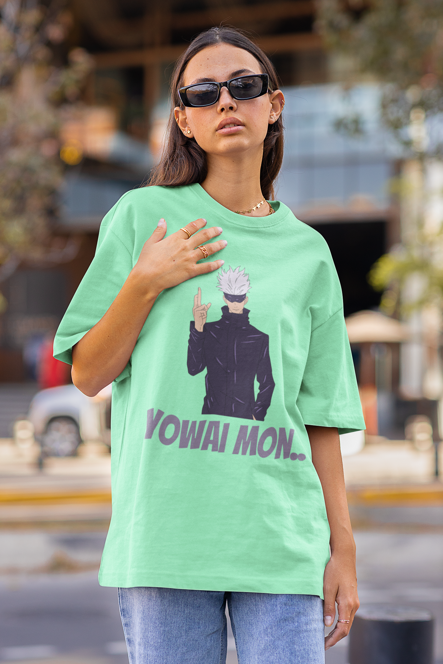 2nd front view of a female model wearing a mint green oversized t-shirt featuring Gojo Satoru with his fingers crossed and the text "Yowai Mon."