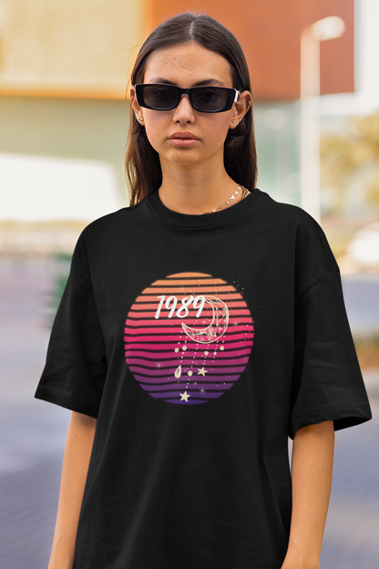 Closeup view of woman wearing black coloured Oversize T-shirt featuring Taylor Swift 1989 design, Taylor's Version, and Eras Tour Merch