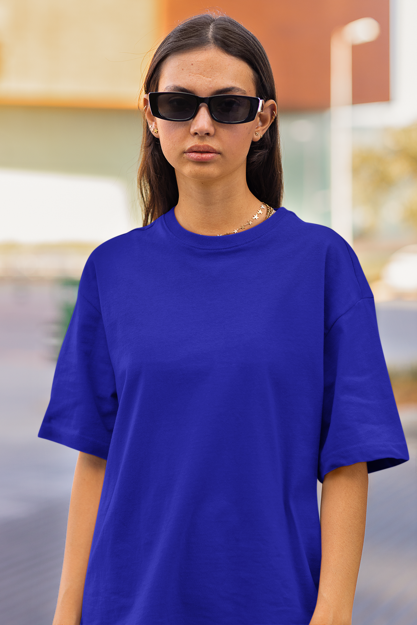 2nd front view of a female model wearing a royal blue oversized t-shirt featuring Crocodile, the Desiccation Master, from the One Piece anime.