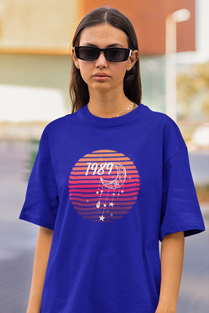 Closeup view of woman wearing blue coloured Oversize T-shirt featuring Taylor Swift 1989 design, Taylor's Version, and Eras Tour Merch