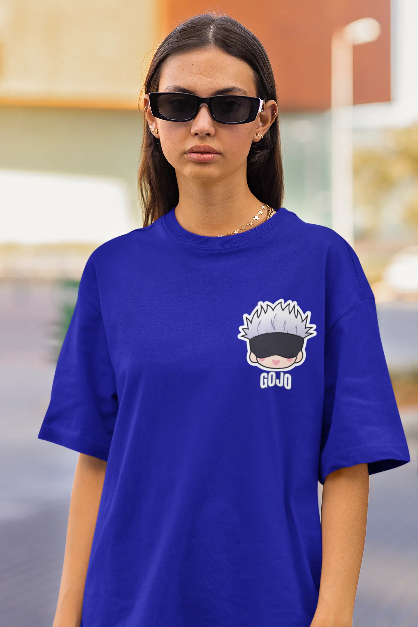 2nd front view of a female model wearing a royal blue oversized t-shirt featuring Gojo Satoru from Jujutsu Kaisen with the text "Satoru Gojo."