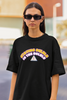 Closeup front view of female model wearing a black oversized t-shirt with the hilarious message 