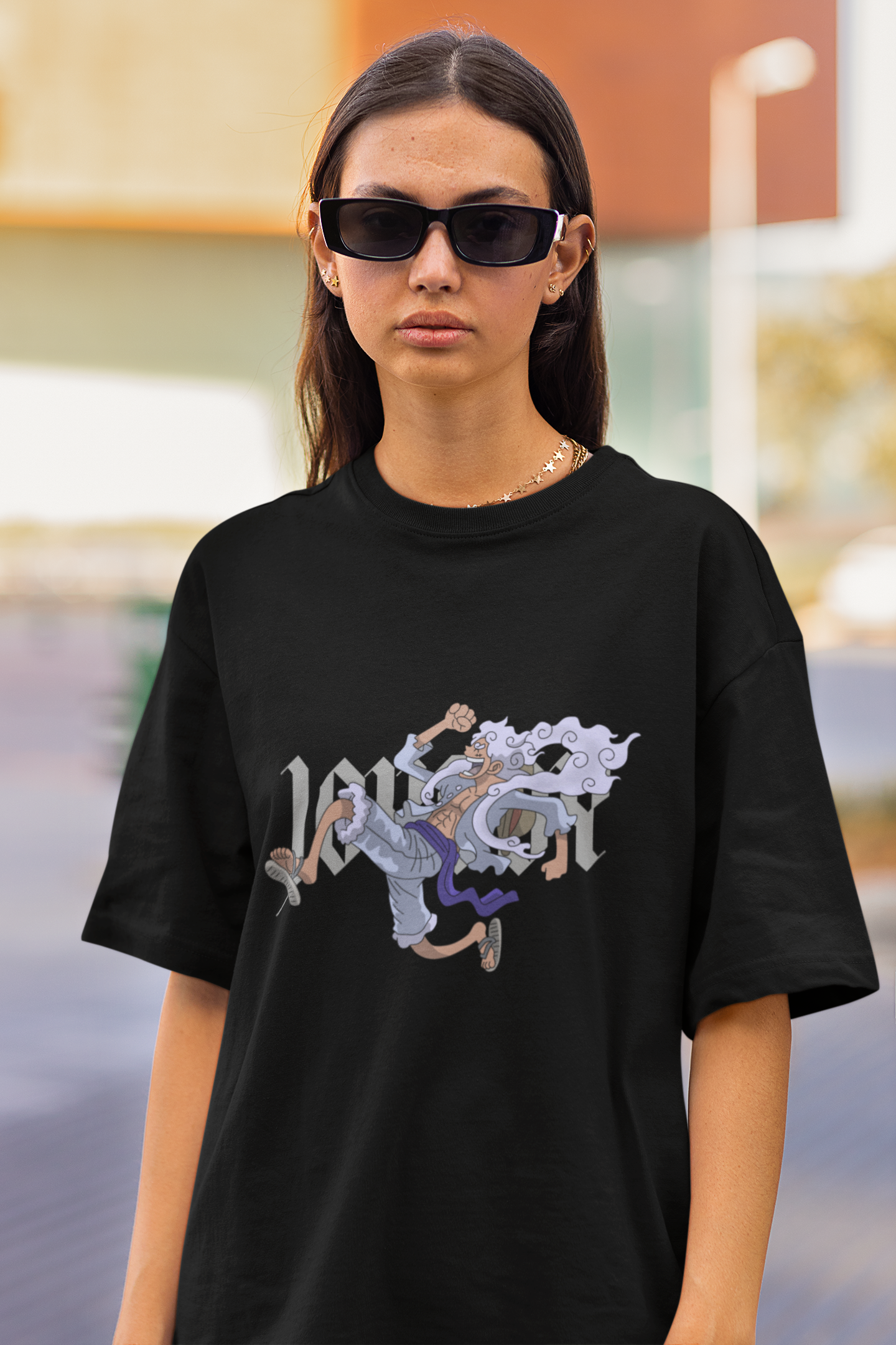2nd front view of a female model wearing a black oversized t-shirt featuring Luffy in his Gear 5 form from the One Piece anime.
