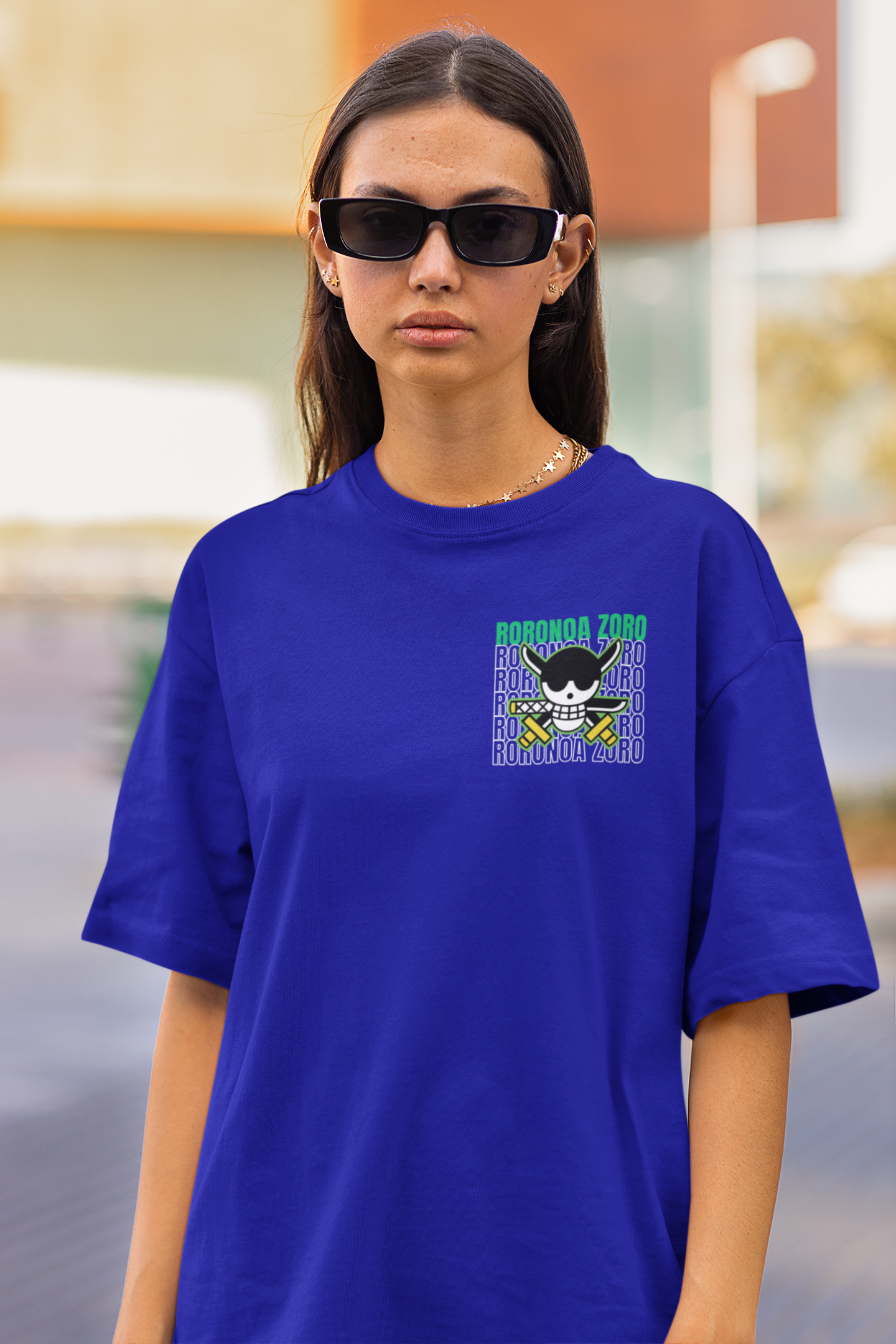3rd front view of a female model wearing a royal blue oversized t-shirt featuring Roronoa Zoro from the One Piece anime.