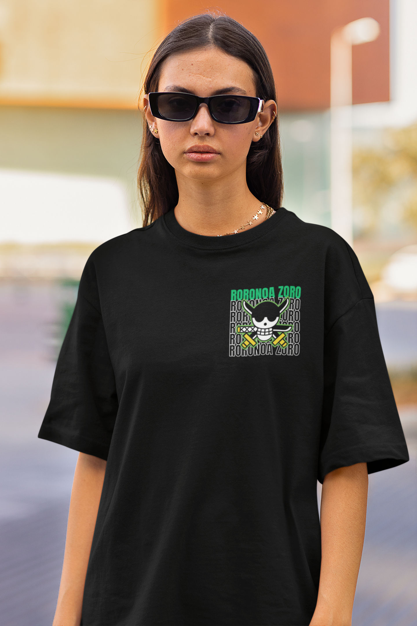 3rd front view of a female model wearing a black oversized t-shirt featuring Roronoa Zoro from the One Piece anime.