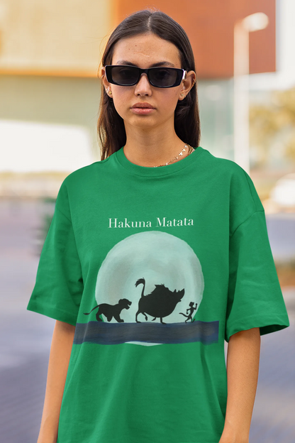Close up view of female model showcasing forest green oversized t-shirts inspired by Hakuna Matata from Disney's Lion King, featuring Pumbaa, Simba and other iconic characters.