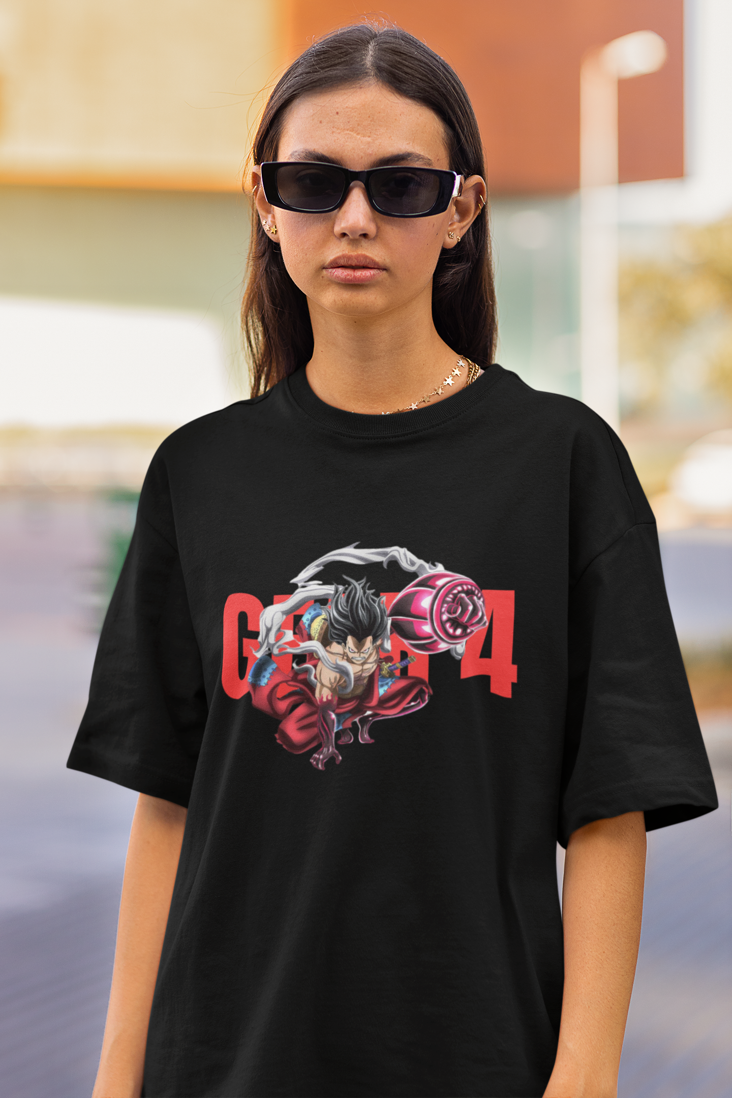 First front view of a female model wearing a black oversized t-shirt featuring Luffy in his Gear 4 Bounceman form from the One Piece anime.