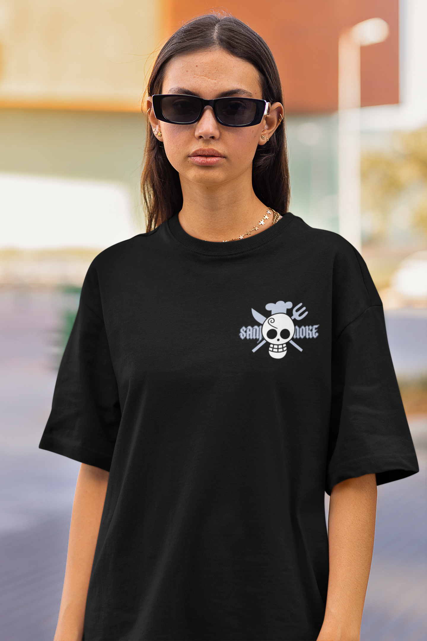 3rd front view of a male model wearing a black oversized t-shirt featuring Sanji's skull and crossbones logo and the text "The Cook and Black Leg."