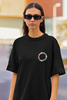 Close up front view of woman wearing black Oversized T-shirt featuring Taylor Swift Midnight design