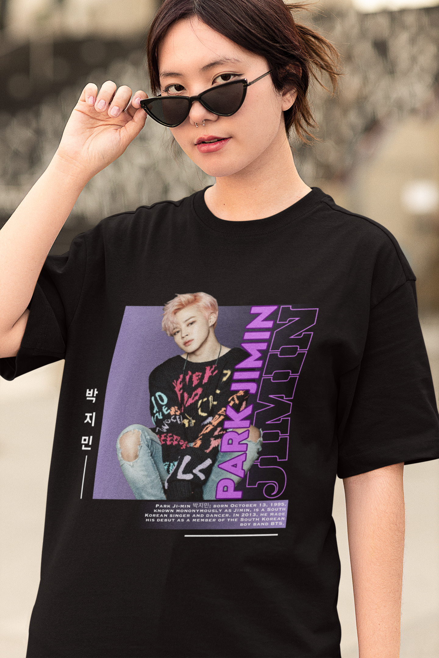 Front view of female model wearing a black oversized t-shirt featuring a bold design inspired by BTS member Park Jimin (Jimin). Ideal for BTS fans (ARMY) and K-Pop enthusiasts who love dance-focused music.