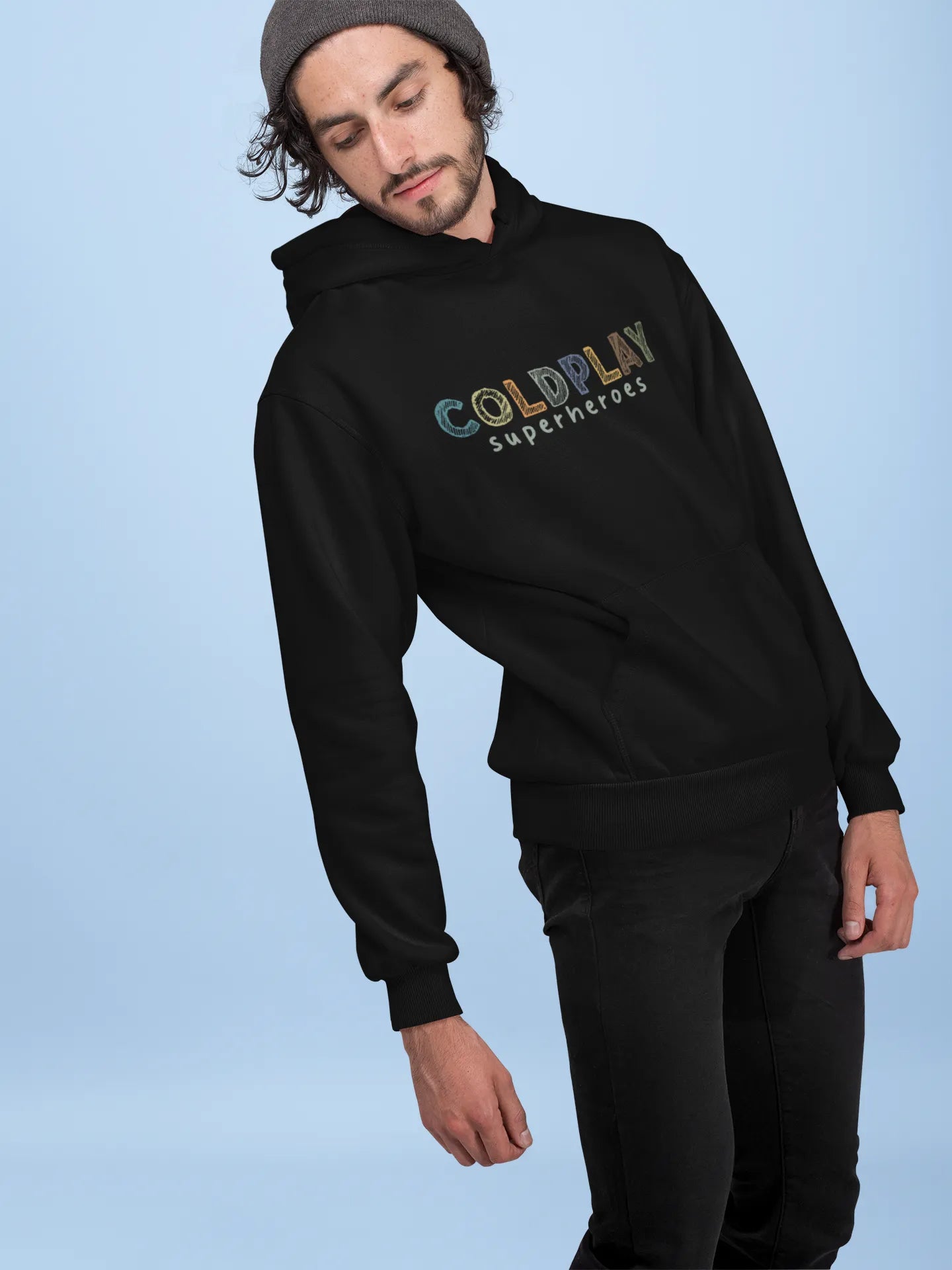 4th front view of a male model wearing an black hoodie with a design inspired by the "Something Just Like This" music video, featuring the word "Superheroes".