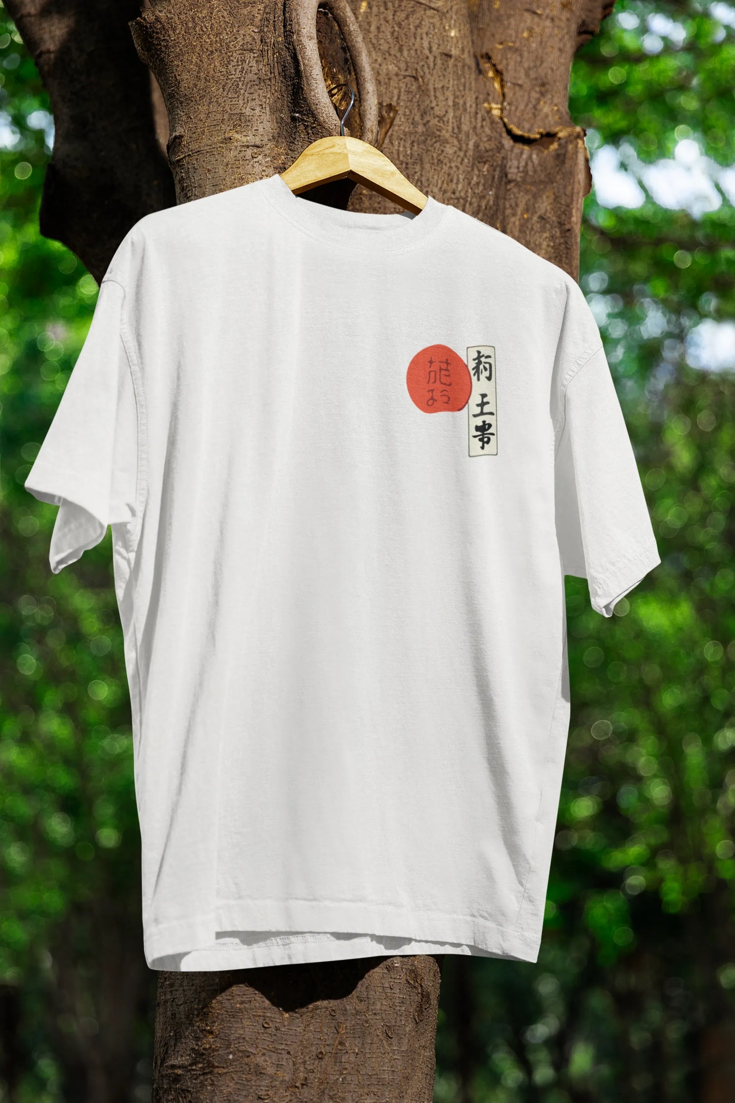 Front view of a off-white oversized tee with a design of a wolf surveying a Japanese landscape.