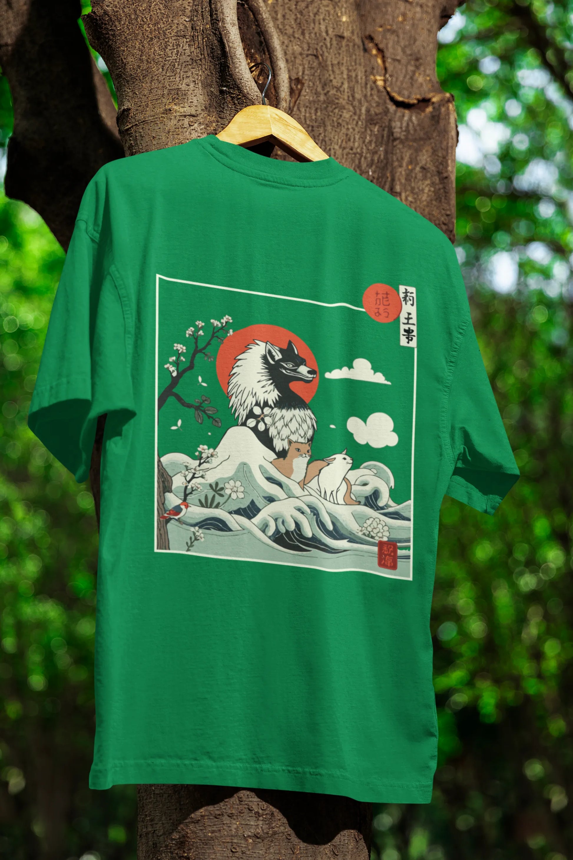 Back view of a forest green oversized tee with a design of a wolf surveying a Japanese landscape.