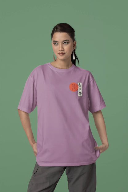 Front view of a female model wearing a dirty purple oversized tee with a design of a wolf surveying a Japanese landscape.