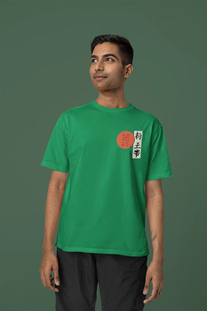 Front view of a male model wearing a forest green oversized tee with a design of a wolf surveying a Japanese landscape.