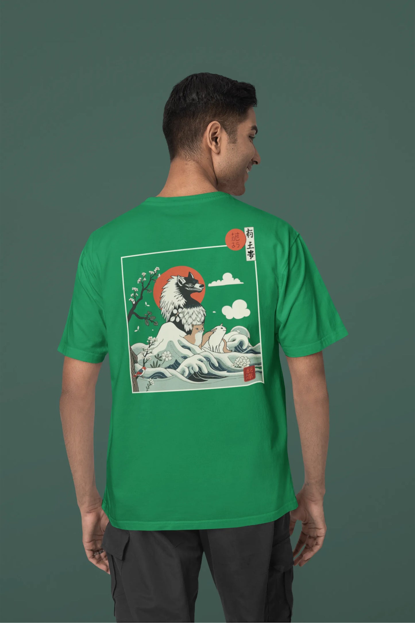 Back view of a male model wearing a forest green oversized tee with a design of a wolf surveying a Japanese landscape.