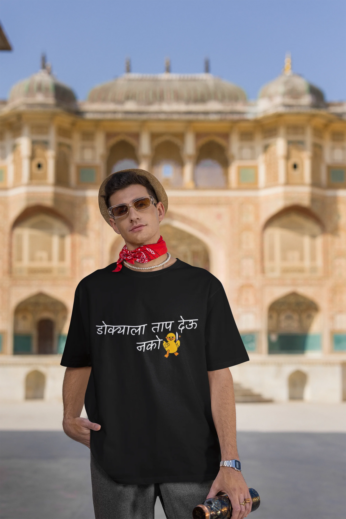 Third front view of a male model wearing a black oversized t-shirt featuring a design inspired by Marathi culture. Perfect for anyone who loves Maharashtra and its vibrant traditions.