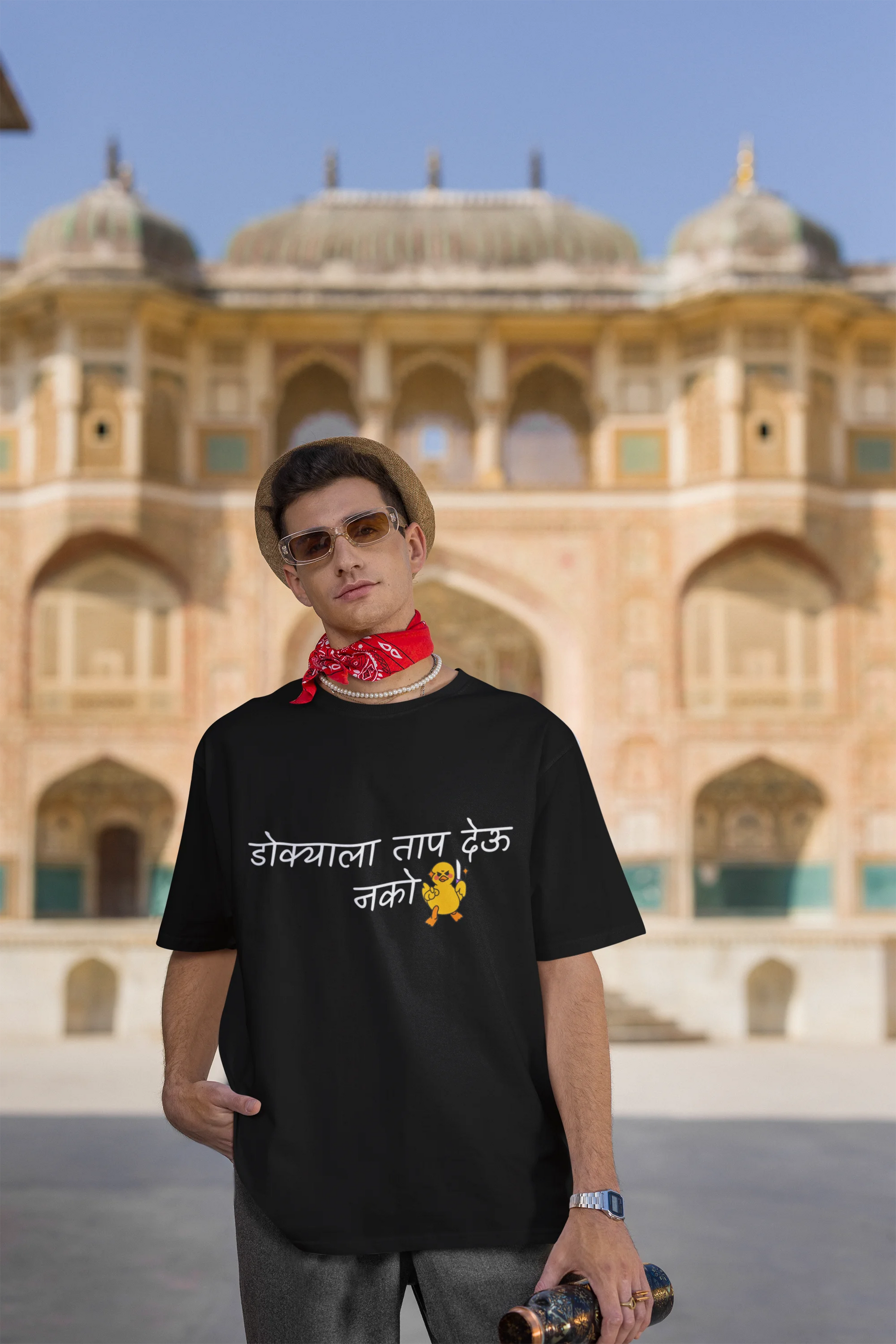 Third front view of a male model wearing a black oversized t-shirt featuring a design inspired by Marathi culture. Perfect for anyone who loves Maharashtra and its vibrant traditions.