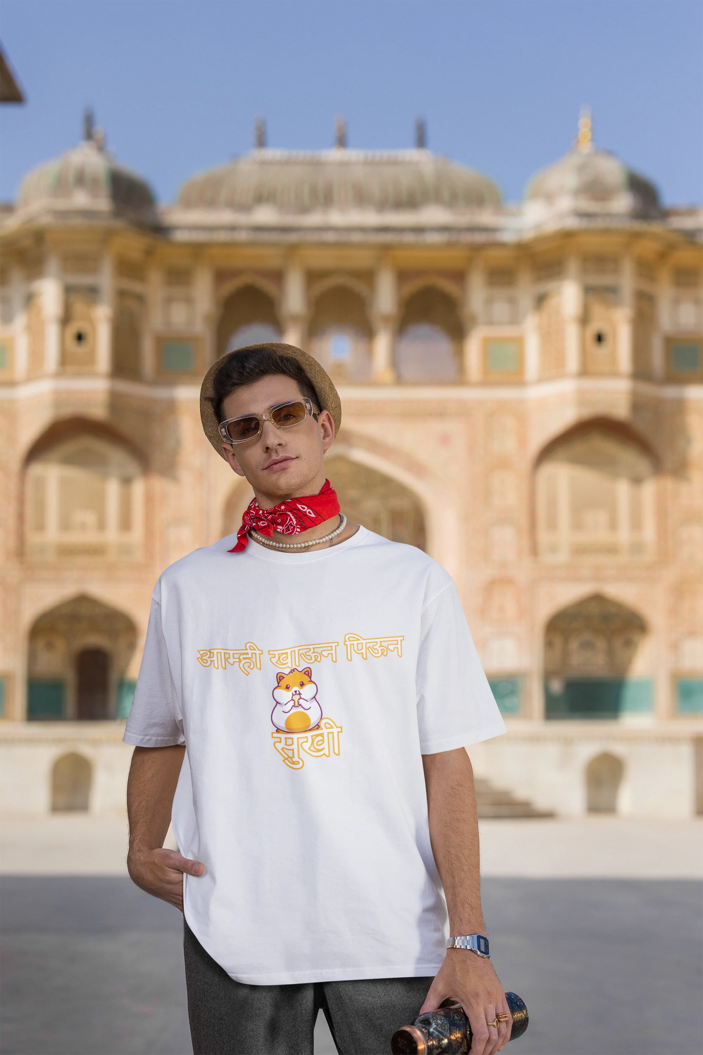 Third front view of male model wearing an off-white oversized t-shirt featuring a design inspired by the Marathi dish "Sukhi," a dry lentil curry. Perfect for fans of Marathi culture, foodies, and anyone who loves a taste of home.