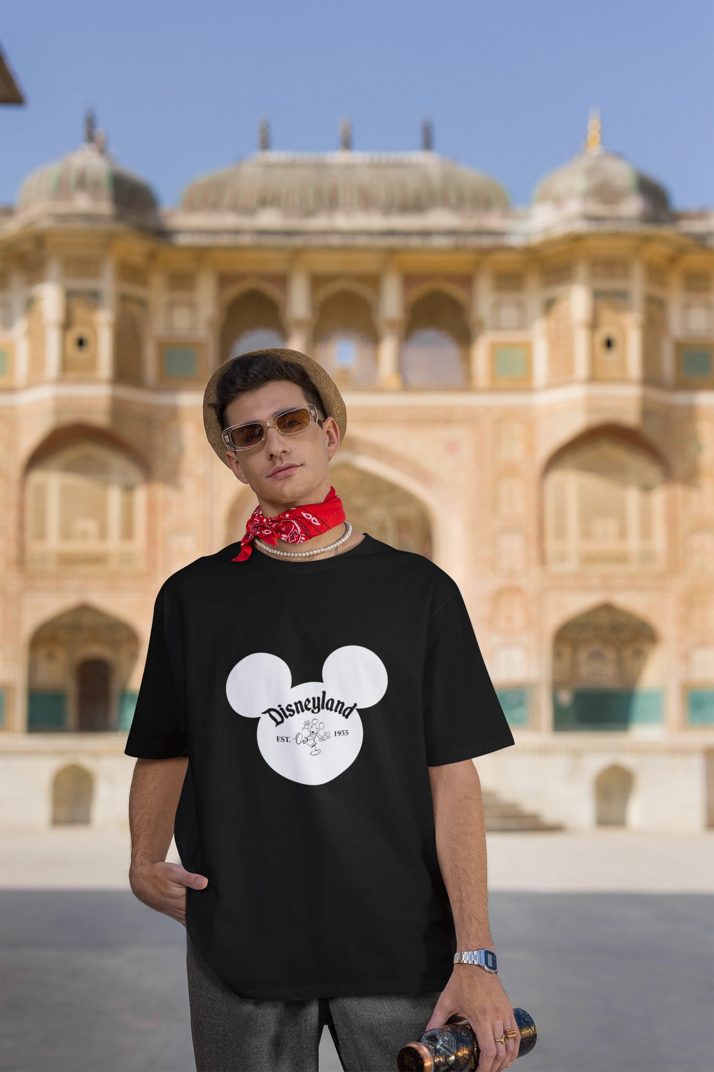 Third image of male model wearing a black oversized Disney collection t-shirt featuring a classic Disneyland design.