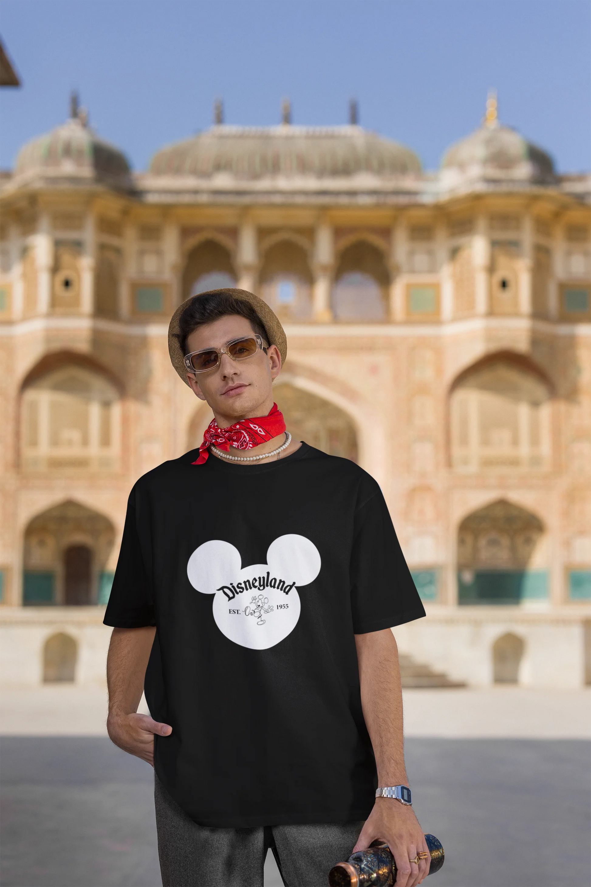Third image of male model wearing a black oversized Disney collection t-shirt featuring a classic Disneyland design.