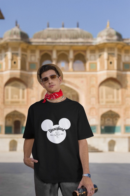 Third image of male model wearing a black oversized Disney collection t-shirt featuring a classic Disneyland design.