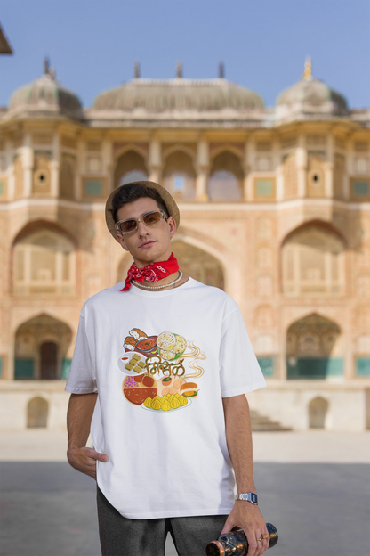 Third front view of male model wearing an off white oversized t-shirt featuring a design inspired by the Marathi dish Misal Pav. Ideal for fans of Marathi culture, foodies, and anyone who loves a flavorful meal.