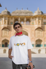 Third front view of a male model wearing an off-white oversized t-shirt with a colorful design that celebrates Marathi culture. Ideal for anyone who loves Maharashtra and its vibrant heritage.