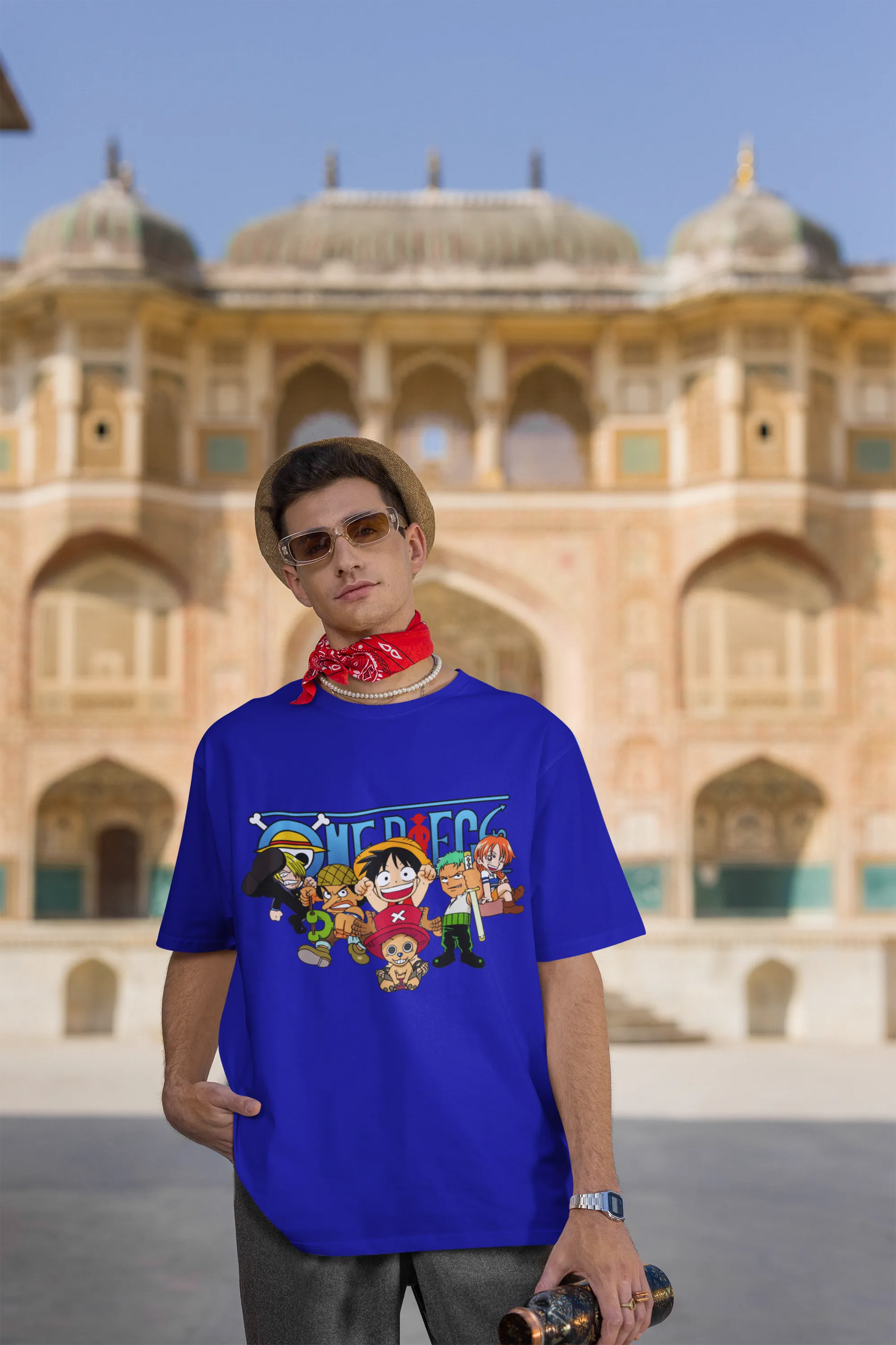 3rd front view of a male model wearing a royal blue oversized t-shirt featuring chibi versions of the Straw Hat Crew from the One Piece anime.