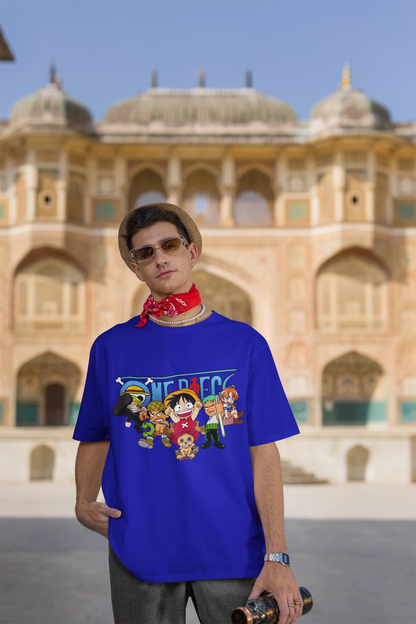 3rd front view of a male model wearing a royal blue oversized t-shirt featuring chibi versions of the Straw Hat Crew from the One Piece anime.