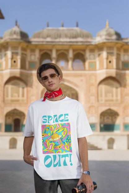 Third image of male model wearing an off white oversized "Spaced Out" t-shirt featuring a vibrant color mashup design that evokes a sense of space exploration, playful aliens, and distant galaxies.