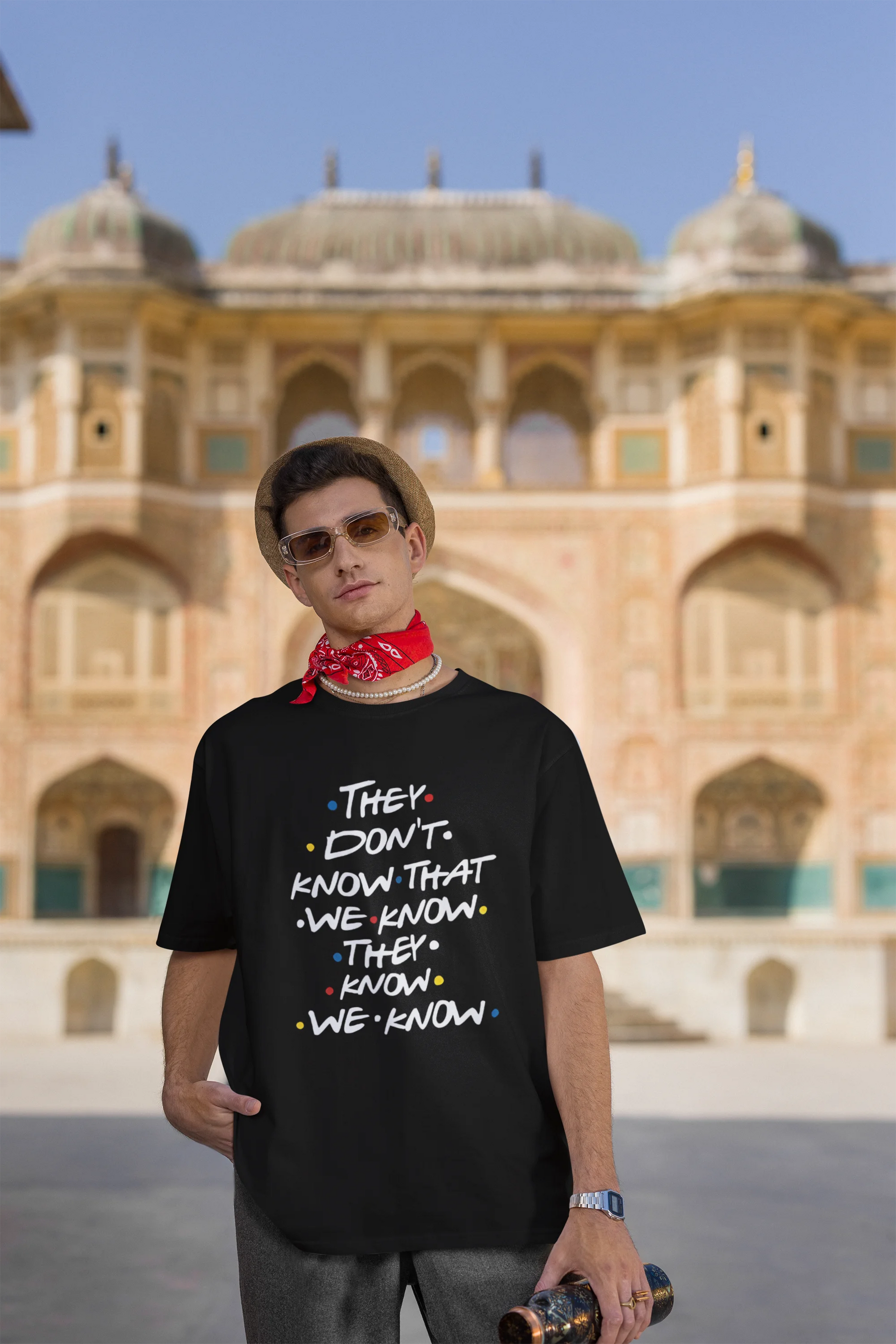 Third image of male model wearing black oversized t-shirt with F.R.I.E.N.D.S series inspired designs, embodying Phoebe's unique humor with the quote 'They Know We Know'