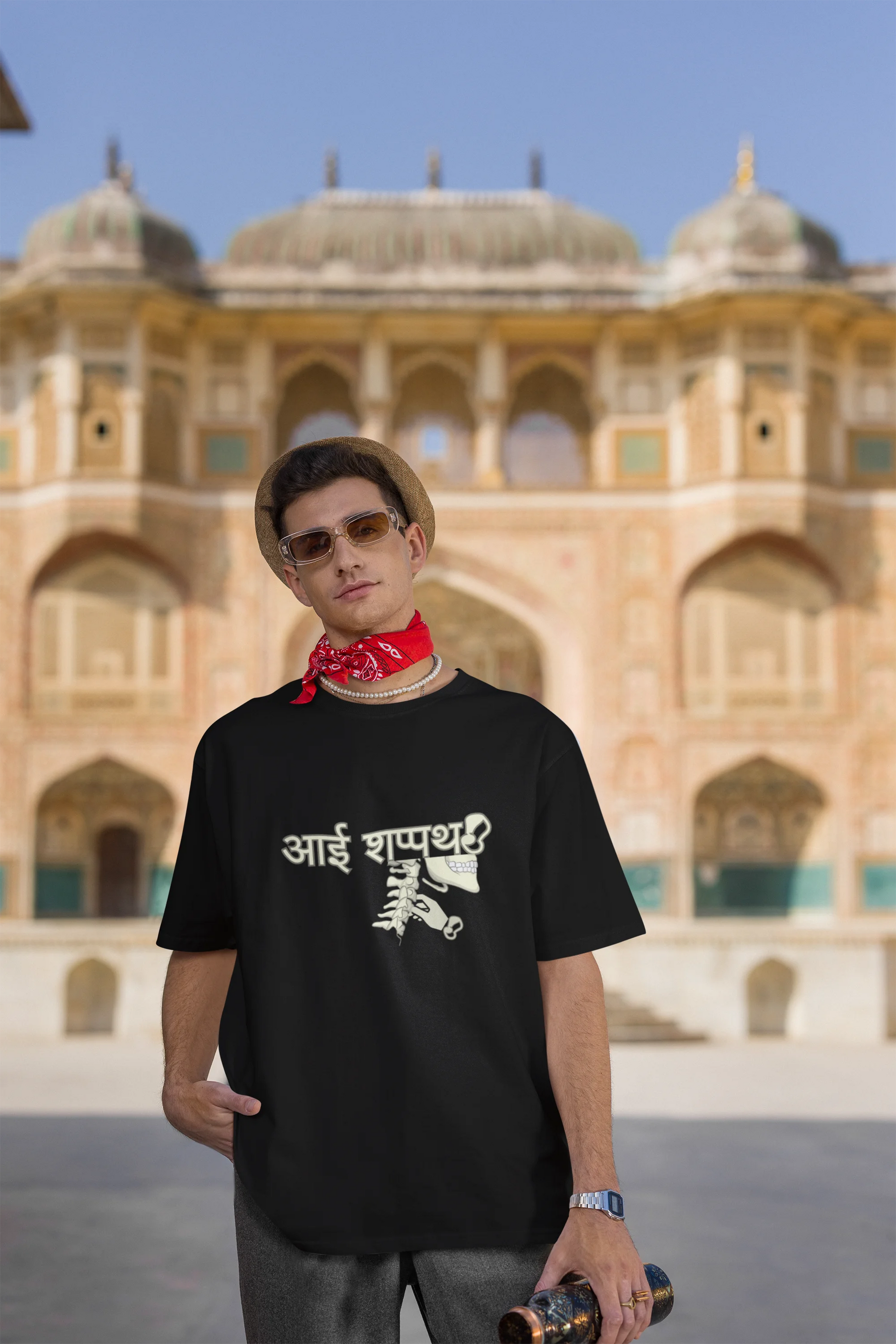 Third front view of male model wearing a black oversized t-shirt featuring a design inspired by the Marathi saying "Aai Sapath." Perfect for fans of Marathi culture and anyone who wants to celebrate their heritage.