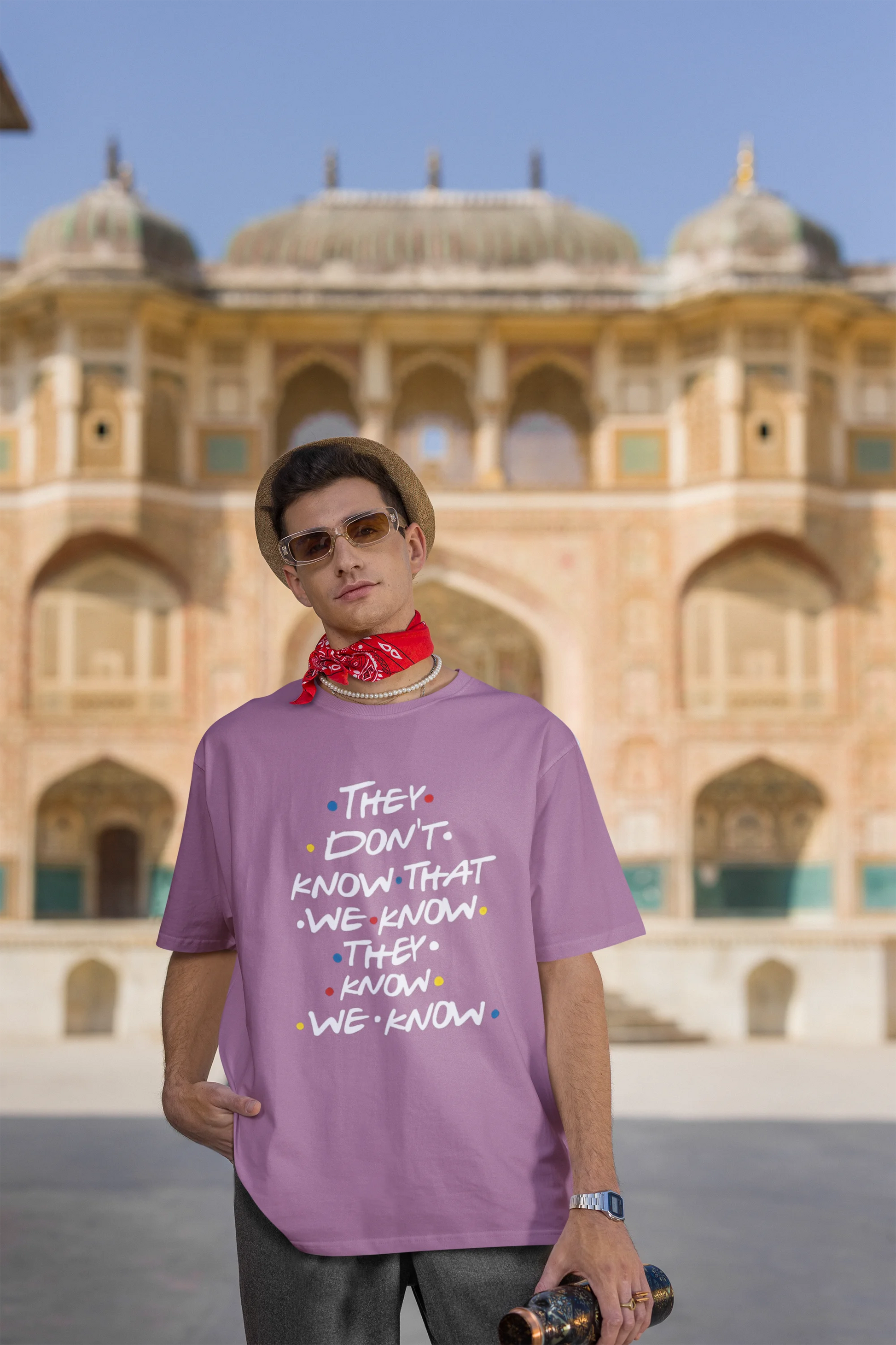 Third image of male model wearing dirty purple oversized t-shirt with F.R.I.E.N.D.S series inspired designs, embodying Phoebe's unique humor with the quote 'They Know We Know'