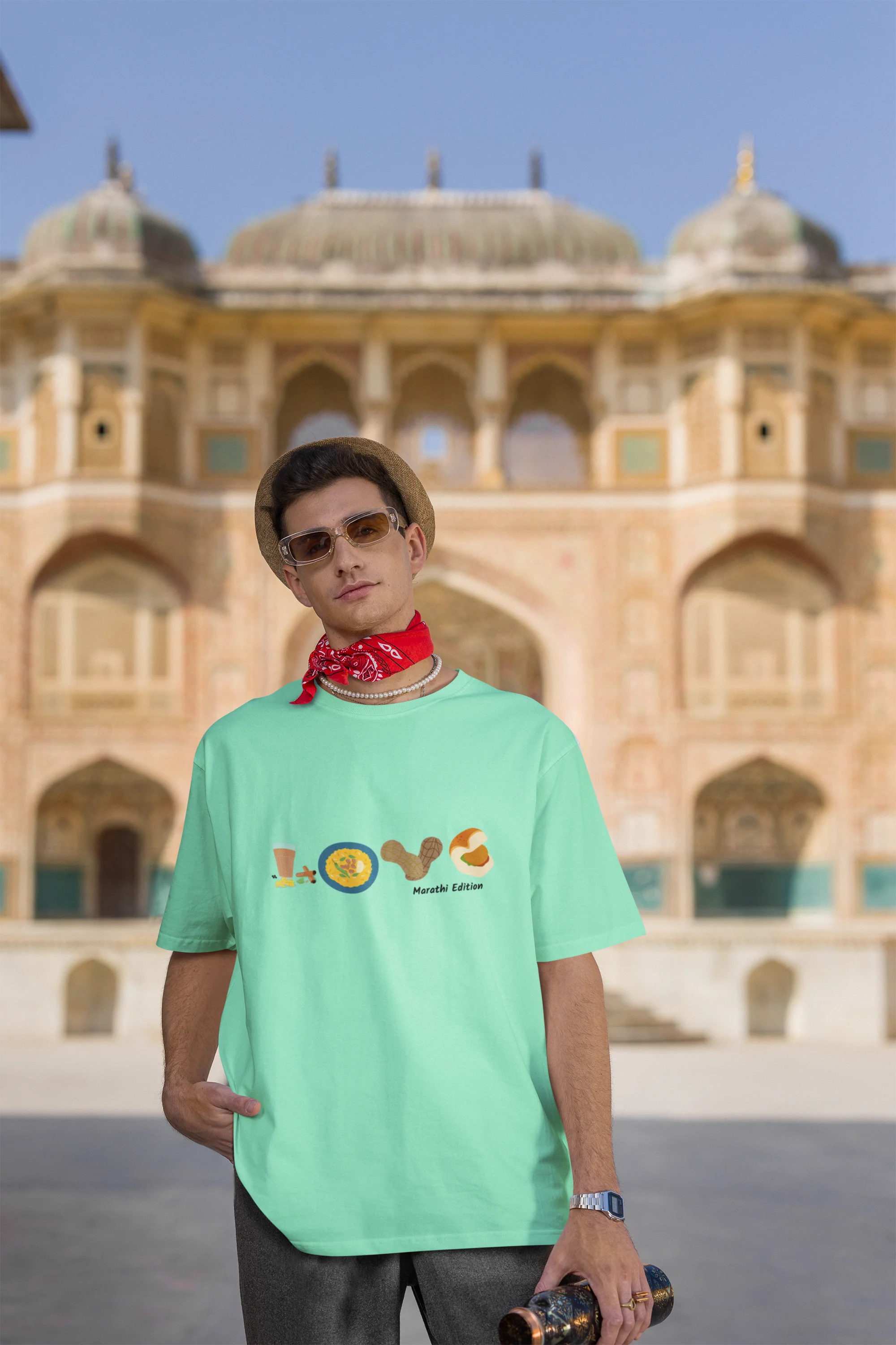 Third front view of a male model wearing an mint green oversized t-shirt with a colorful design that celebrates Marathi culture. Ideal for anyone who loves Maharashtra and its vibrant heritage.