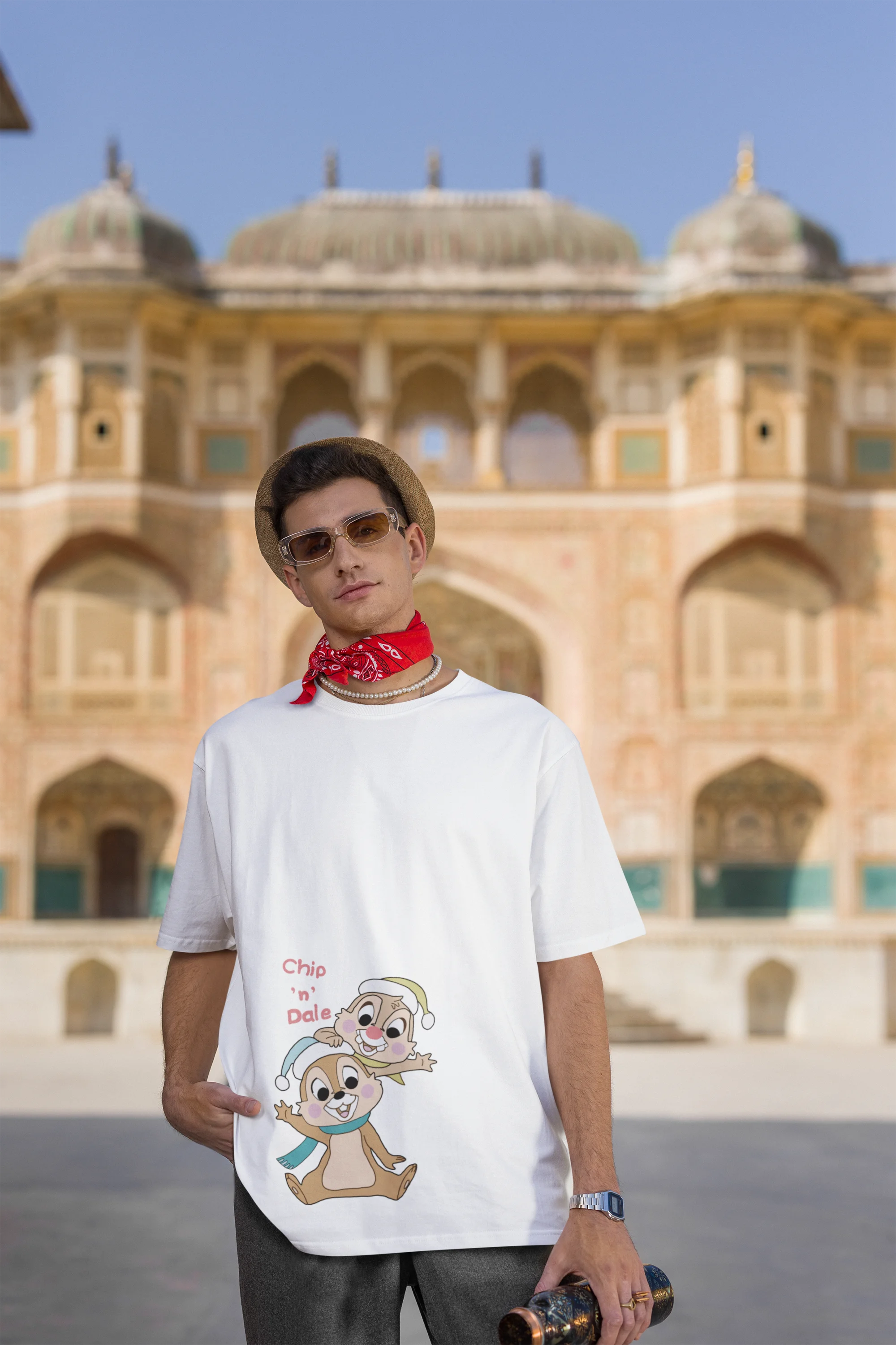 Third image of male model wearing off-white oversized tee with a Disney's Chip and Dale design, featuring the adorable duo in a playful scene.