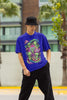 Front view of a male model wearing a royal blue oversized t-shirt with a psychedelic design featuring green aliens and spaceships, perfect for a hippie, trance, or groovy style.